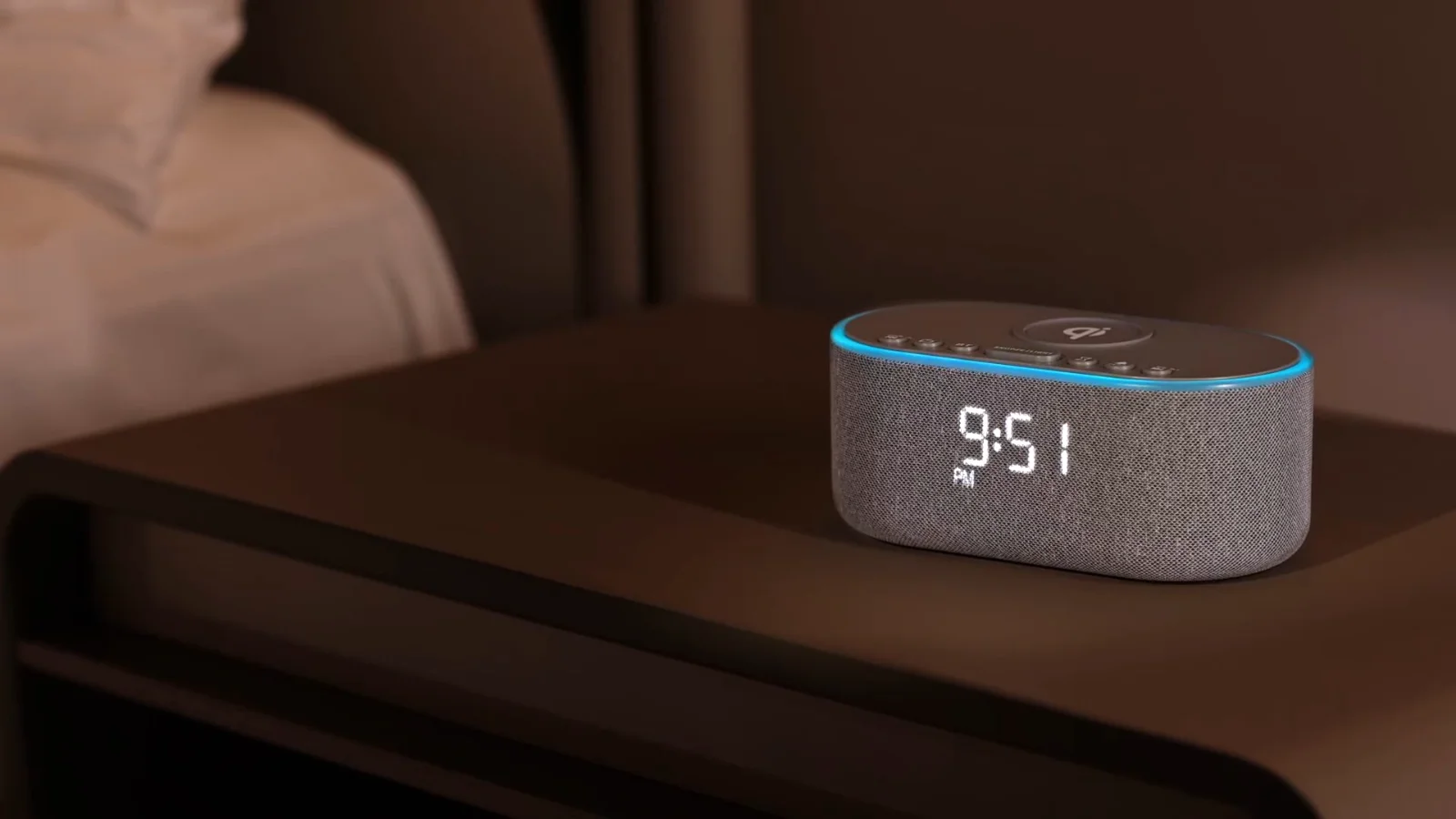 An Odokee UE268 charging clock radio glowing on a bedside table beside a bed